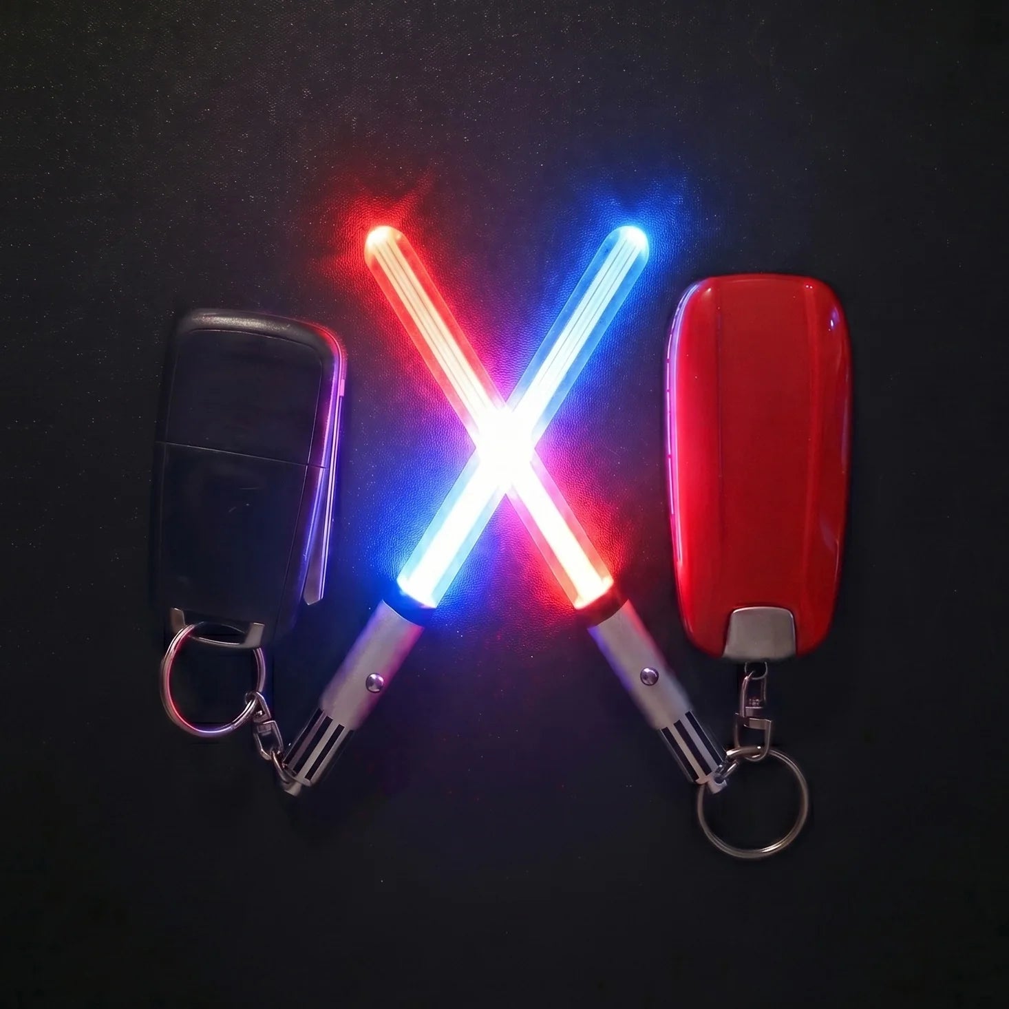 Red and blue Pocket Sabers next to car key fobs